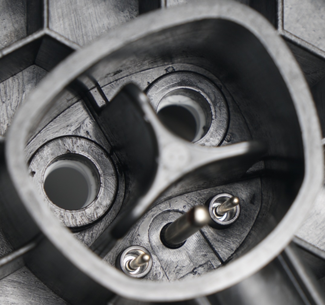 Overmolded EV charging port with integrated metal terminals and reinforced plastic housing.