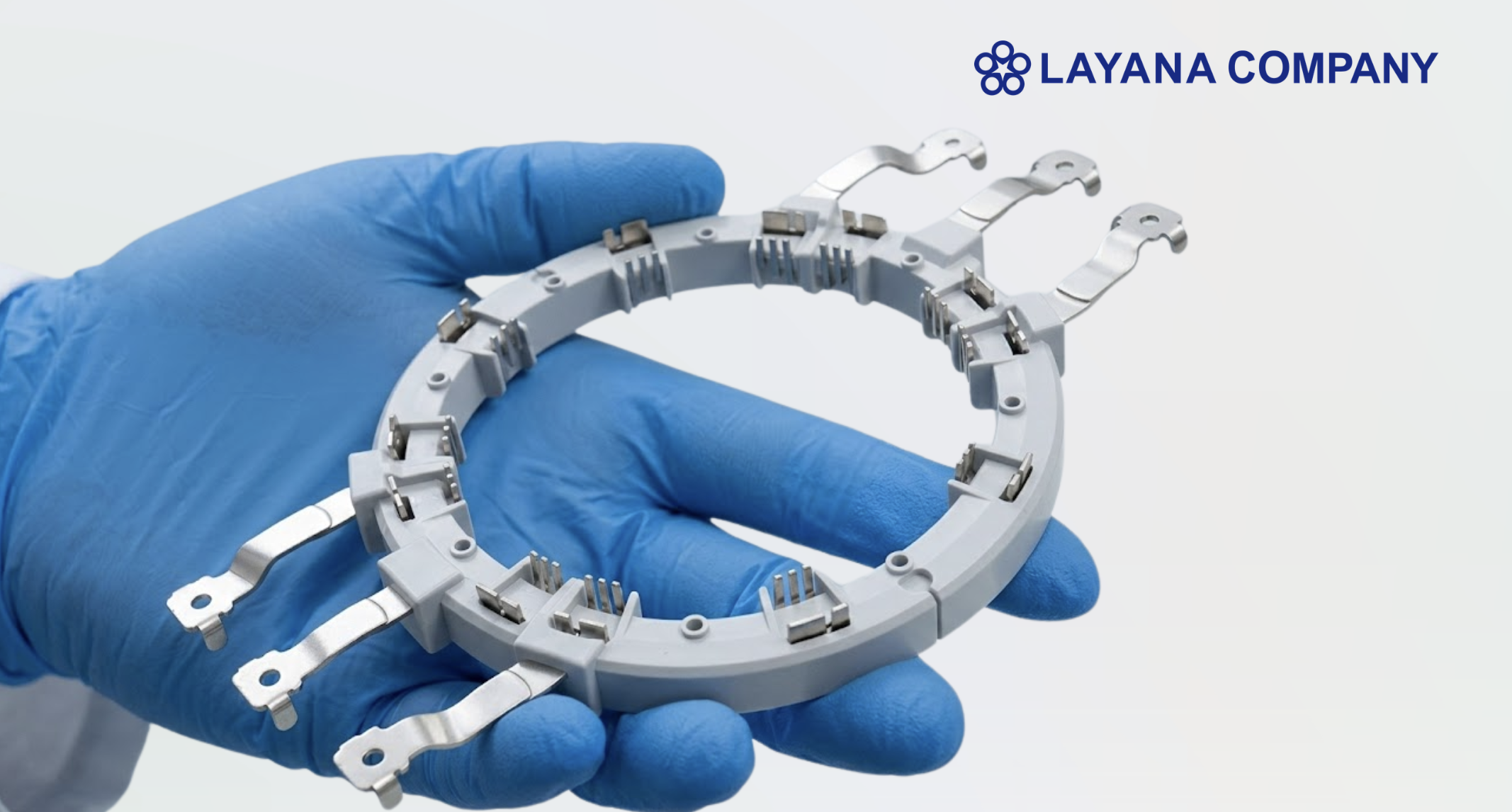 Layana overmolded assembly component with integrated metal terminals and precision molded plastic structure.