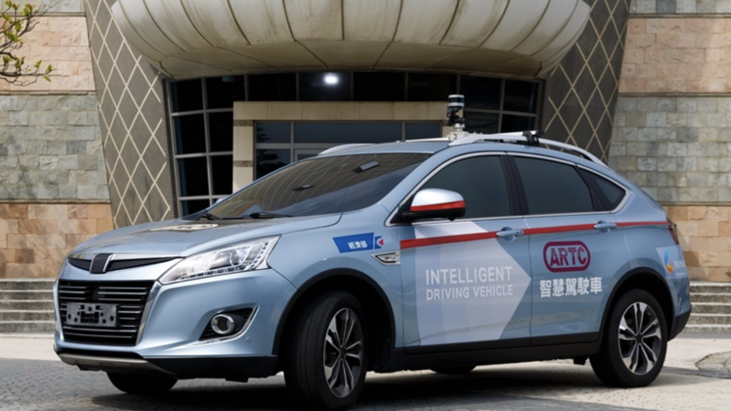 ARTC intelligent test vehicle parked outside the Automotive Research & Testing Center in Taiwan, supporting automotive validation and testing collaboration.